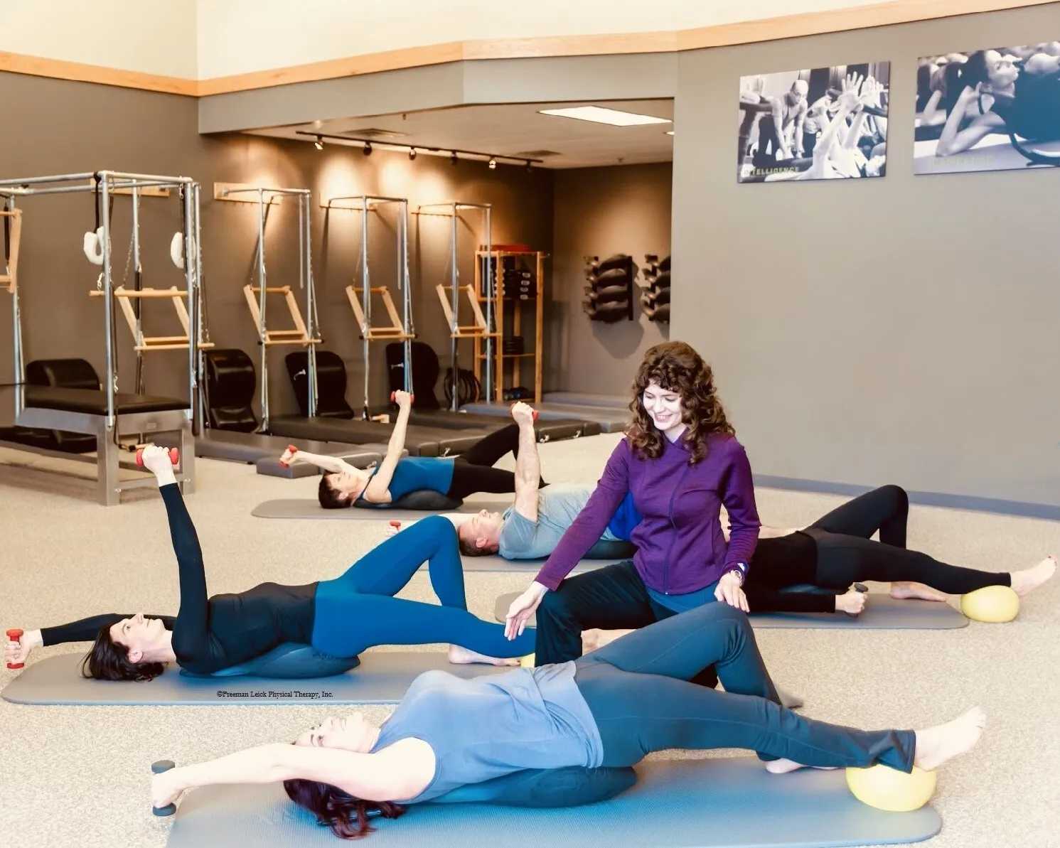 Group session at Freeman Leick Physical Therapy using Oov devices with weights and an exercise ball